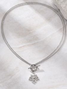 Detail of silver double-layered chain necklace with maple leaf pendant and OT toggle clasp