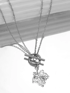 Detail of stainless steel necklace featuring OT toggle clasp and hollow maple leaf pendant