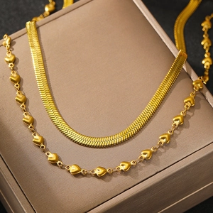 Golden herringbone choker necklace and delicate heart chain set with high-polished finish