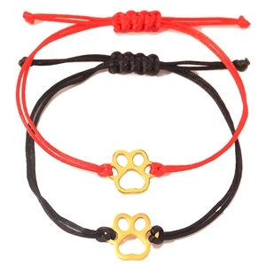 Detail of adjustable woven red and black rope bracelets with gold cat paw charms
