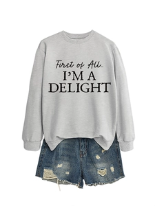 Gray crewneck sweatshirt with 'First of All I'M A DELIGHT' text and denim shorts