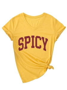 Detail showing bright yellow V-neck T-shirt with red SPICY lettering and side knot