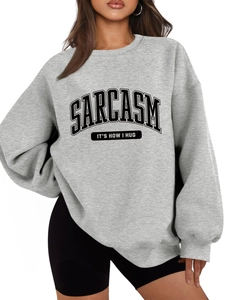 Detail of the gray SARCASM slogan sweatshirt showing ribbed cuffs and textured knit fabric