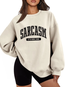 Close-up of Sarcasm It's How I Hug slogan print on cream oversized fleece sweatshirt
