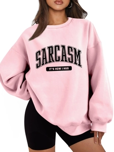 Detail of pink oversized sweatshirt featuring Sarcasm It's How I Hug black letter print