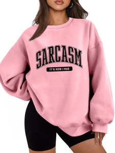 Close-up of Sarcasm text print on a pink oversized thermal sweatshirt for women
