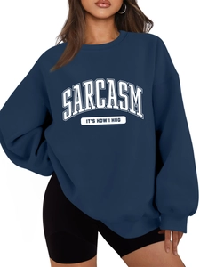 Detail of navy blue oversized sweatshirt with white Sarcasm print and ribbed cuffs
