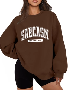 Detailed view of the SARCASM letter print on this thick brown crewneck sweatshirt