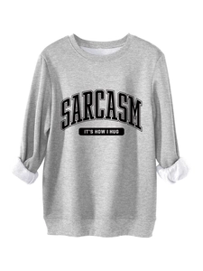 Detail of gray sweatshirt with fleece lining and Sarcasm It's How I Hug black text print