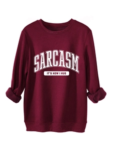 Detail of burgundy fleece sweatshirt with Sarcasm It's How I Hug text and ribbed cuffs
