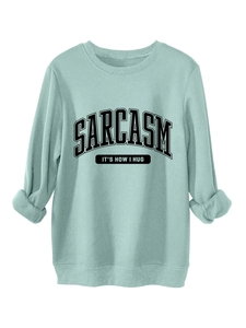 Detail of SARCASM IT'S HOW I HUG slogan printed on mint green thick cotton sweatshirt