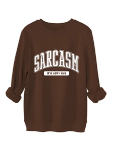 Detail of the white SARCASM slogan print on a comfortable brown crewneck sweatshirt