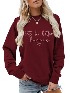 Close-up of let's be better humans slogan print on burgundy cotton sweatshirt