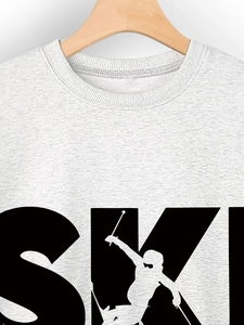Detail of grey crewneck sweatshirt with SKI print and skier silhouette on hanger