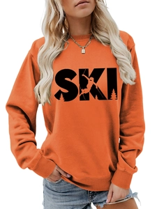 Detail of the SKI graphic print and ribbed neckline on the orange long sleeve sweatshirt