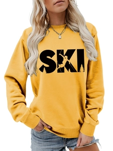 Close-up of SKI graphic print and ribbed cuffs on a yellow long sleeve sweatshirt
