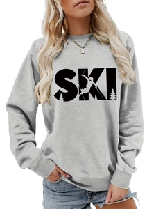 Close-up of light grey crewneck sweatshirt featuring a black SKI graphic with skier silhouette
