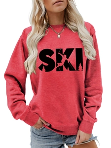 Detail of red crewneck sweatshirt featuring black SKI graphic and ribbed cuffs
