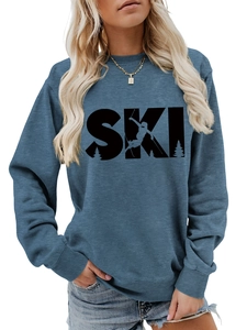 Detailed view of blue crewneck sweatshirt featuring a black SKI print with skier silhouette