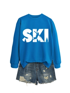 Detail of bright blue crewneck sweatshirt with white SKI graphic and pine tree silhouette