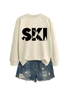 Detail of cream sweatshirt with SKI graphic print and distressed denim shorts set