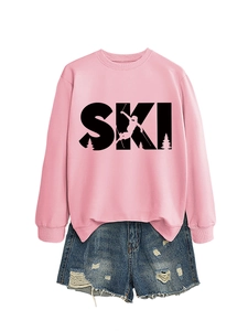 Detailed view of pink crewneck sweatshirt with SKI print and distressed denim shorts