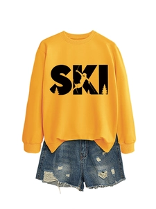 Detail of yellow round neck sweatshirt with black SKI print and blue denim shorts