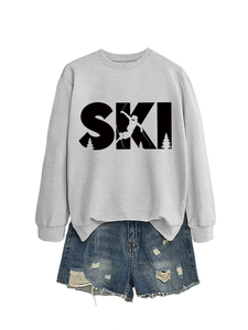 Detail of grey SKI sweatshirt with mountain graphic paired with distressed denim shorts