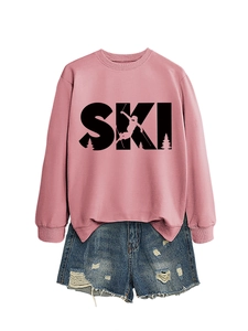 Close-up of pink long-sleeve sweatshirt featuring black SKI graphic with skier silhouette