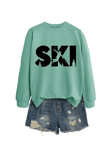 Detail of mint green SKI sweatshirt with graphic print and denim shorts on white background