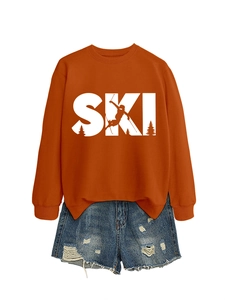 Detail of orange long sleeve sweatshirt with white SKI print and distressed denim shorts