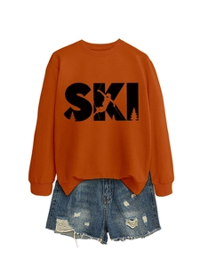 Detail of orange crewneck SKI sweatshirt paired with distressed denim shorts on white