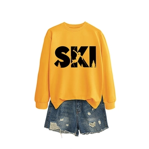 Yellow SKI graphic sweatshirt with denim shorts set on plain white background