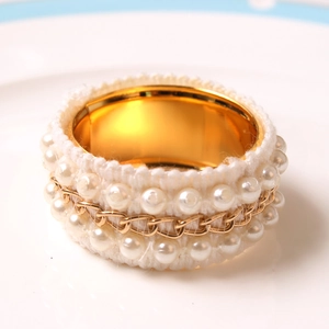DIY pearl chain napkin ring with white lace fabric and gold plating on white plate