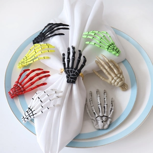 Detailed view of skull hand napkin rings showing bone texture and various colors