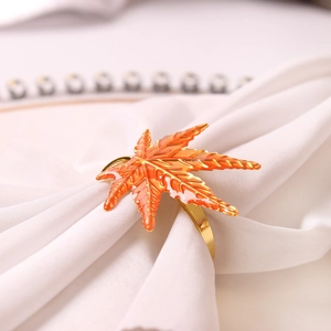 Maple leaf napkin ring with orange enamel finish and gold veins for autumn dining decor