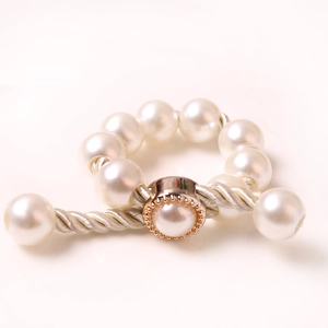 Modern white pearl magnetic curtain tieback with woven rope and ornate buckle detail