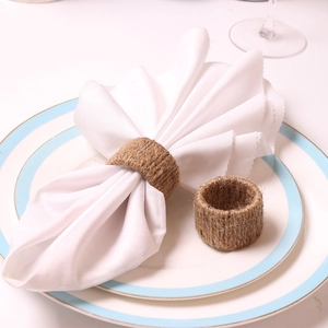 Handmade burlap napkin ring set with rustic jute weaving on white dinner plate