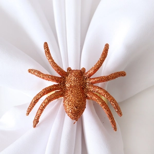 Sparkly orange spider napkin ring with glitter finish and gold metal band for Halloween