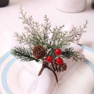 Christmas napkin ring with cedar pine needles, red berries and natural pine cone decor