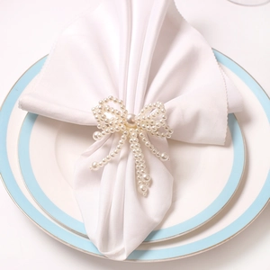 Elegant pearl bow napkin ring handcrafted with white pearls for luxury table decoration