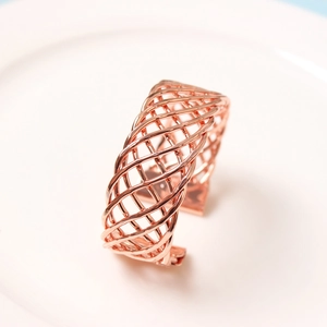 Detailed view of rose gold woven mesh open cuff bracelet with polished mirror finish