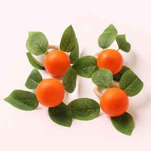 Set of 4 lifelike artificial orange napkin rings with green leaves and woven bases