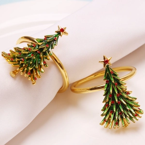 Set of two gold metal Christmas tree napkin rings with green enamel and red rhinestones