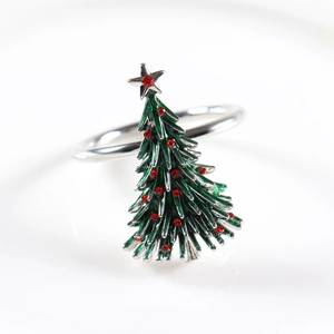 Detail of Christmas tree napkin ring with green enamel, red rhinestones and silver star