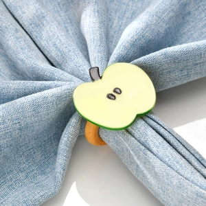 Green apple napkin ring with realistic fruit slice on rustic wood texture loop