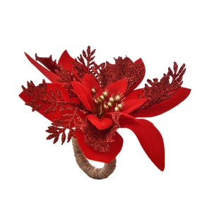 Macro detail of red poinsettia napkin ring with sequined petals and rustic twine loop