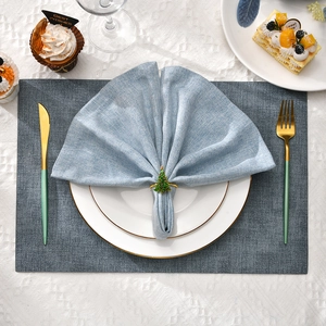 Christmas cedar tree napkin ring with red accents on blue linen napkin for table decor