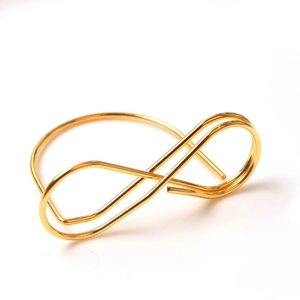 Close-up of golden infinity star card holder made of polished stainless steel wires