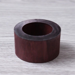 Detailed view of dark red natural wood napkin ring with polished smooth texture and grain